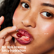 Close-up of a person applying lip balm with text 'for lips craving juicy hydration' and brand name 'jam jar'.