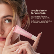 Woman holding a pink lip balm with text about its ingredients on a dark background