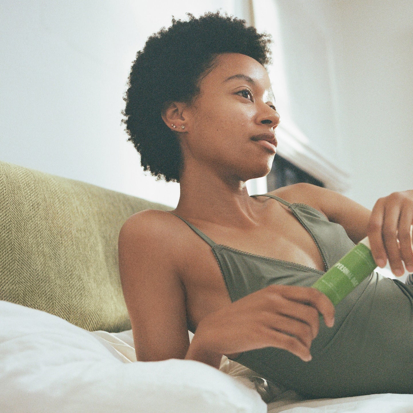 A girl is sitting on the couch 